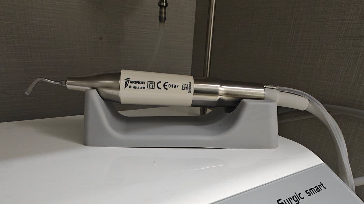 HB-2 LED ultrasonic handpiece with cutting tip resting on cradle