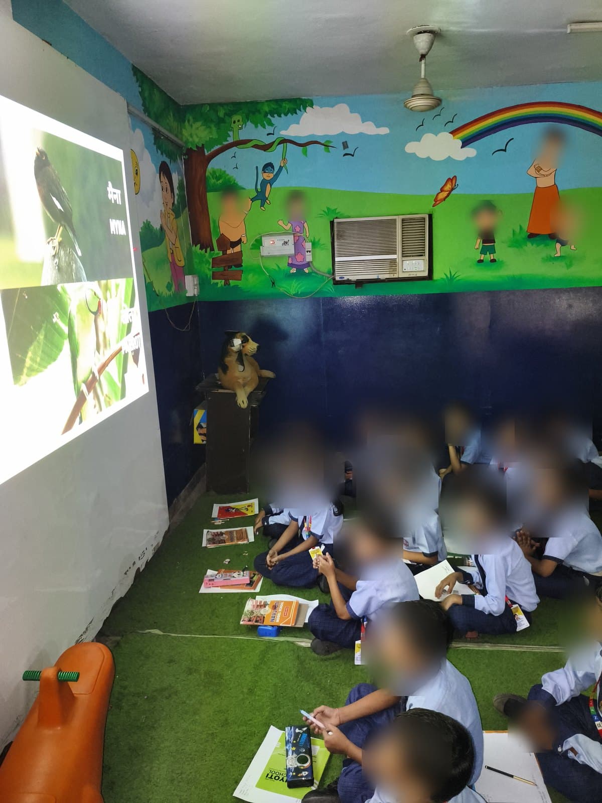 Students looking up at a slide identifying the myna during a Wildlife Rescue class
